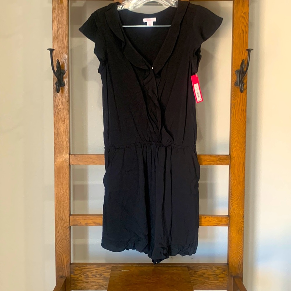 Women’s Xhiliration romper with ruffle detailing. New with tags